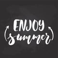 Enjoy summer - hand drawn seasons holiday lettering phrase isolated on the black chalkboard background. Fun brush ink Royalty Free Stock Photo