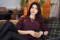 Enjoy weekend. Asian girl relaxing, drinking coffee and sitting on a couch Royalty Free Stock Photo