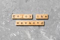 Enjoy the weekend word written on wood block. Enjoy the weekend text on cement table for your desing, Top view concept Royalty Free Stock Photo