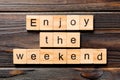 Enjoy the weekend word written on wood block. Enjoy the weekend text on wooden table for your desing, Top view concept Royalty Free Stock Photo