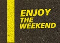 Enjoy the weekend written on the road. Royalty Free Stock Photo