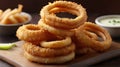 ! Crispy golden-brown onion rings stacked on a plate sound delicious! Royalty Free Stock Photo