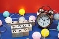 Enjoy Your Day alphabet letter and alarm clock decorate with LED cotton ball on blue and red background