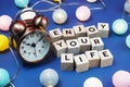 Enjoy Your Life alphabet letter and alarm clock decorate with LED cotton ball on blue background