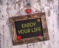 Enjoy your life written on Vintage sign board