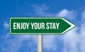 Enjoy your stay road sign on blue sky background Royalty Free Stock Photo