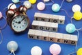 Enjoy Your Weekend alphabet letter and alarm clock decorate with LED cotton ball on blue background