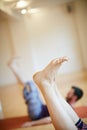 Enjoying all the health benefits of yoga. a womans legs as shes doing yoga indoors.