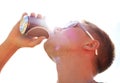 Enjoying a beer. Closeup of a young man wearing sunglasses drinking a beer outside. Royalty Free Stock Photo