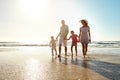 Enjoying a bright and beautiful day together. a family enjoying some quality time together at the beach. Royalty Free Stock Photo