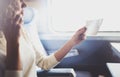 Enjoying business travel concept. Young beautiful brunette tourist girl travelling on the train sitting near the window