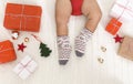 Cute baby legs in warm woolen winter socks with Xmas gifts