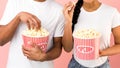 Enjoying cinema snack. Couple eating popcorn, closeup