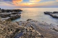 Enjoying the colorful sunset on a beach with rocks on the Adriatic Sea coast Istria Croatia Royalty Free Stock Photo