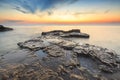 Enjoying the colorful sunset on a beach with rocks on the Adriatic Sea coast Istria Croatia Royalty Free Stock Photo