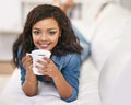 Enjoying the comforts of home. Portrait of a young woman drinking a cup of coffee at home. Royalty Free Stock Photo