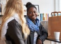 Enjoying a cup of coffee together. Two young women buying coffee together. Royalty Free Stock Photo