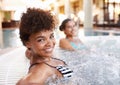 Enjoying a day of relaxation with my best friend. two gorgeous young women in a jacuzzi. Royalty Free Stock Photo