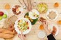 Enjoying dinner with friends. Top view of group of people having dinner together while sitting at wooden table Royalty Free Stock Photo