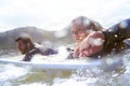 Enjoying an epic surfing session. a young couple out surfing together.