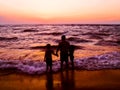 Enjoying the evening sea breeze on bright orange sunset.