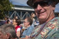 Enjoying the event, mature man with beads and colorful shirt smiles at National Jazz Festival