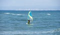 Enjoying extreme windsurfing and ocean waves on a hot sunny day.