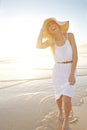 Enjoying the feel of cool water on her feet. a gorgeous young woman walking on the beach. Royalty Free Stock Photo