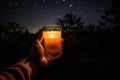 Enjoying glass of orange juice at campsite with cozy campfire and starry night sky. Generative AI.