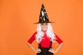 Enjoying great party. mystery witch. small child witch hat. trick or treat. supernatural charmer gray hair. kid orange