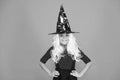 Enjoying great party. mystery witch. small child witch hat. trick or treat. supernatural charmer gray hair. kid orange