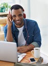 Enjoying a great playlist for work. A handsome casually dressed businessman working in his office. Royalty Free Stock Photo