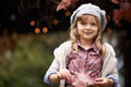 Enjoying her Autumny garden. Portrait of a cute little girl enjoying an autumn day in the garden. Royalty Free Stock Photo