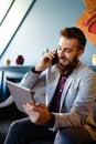 Enjoying his work. Happy young successful businessman talking on the mobile phone Royalty Free Stock Photo