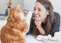 Enjoying a lazy day with her furriest friend. a young woman playing with her cat at home. Royalty Free Stock Photo