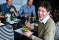 Enjoying lunch with colleagues and friends. Portrait of an office worker eating lunch with coworkers at a boardroom Royalty Free Stock Photo