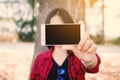 Enjoying moment woman using smartphone sitting under the big tree on park Royalty Free Stock Photo