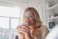 Enjoying morning coffee. Attractive young woman holding a cup an Royalty Free Stock Photo