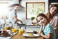 Enjoying the most important meal of the day together. a little girl having breakfast with her parents at home.