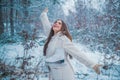 Enjoying nature wintertime. Vintage winter person. Girl playing with snow in park. Beautiful young woman laughing Royalty Free Stock Photo