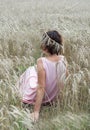 Enjoying the nature. Woman sitting in wheat field back view Royalty Free Stock Photo