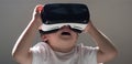 Enjoying new technology. Little child in VR headset. Small child wear wireless VR glasses. Using future technology. The Royalty Free Stock Photo