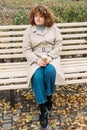 enjoying outdoors dreamy girl bench autumn coffee Royalty Free Stock Photo