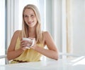 Enjoying a pleasant morning. an attractive young woman drinking a coffee at home. Royalty Free Stock Photo