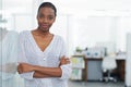 Enjoying a relaxed day at work. Portrait of a young business woman standing with her arms crossed. Royalty Free Stock Photo