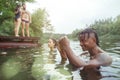Enjoying river party with friends. Group of beautiful happy young people at the river together Royalty Free Stock Photo