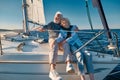 Enjoying sailing. Happy lovely senior family couple hugging and relaxing on a sail boat or yacht deck floating in a calm Royalty Free Stock Photo