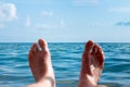 I enjoy the sea. A man lies on the beach opposite the sea Royalty Free Stock Photo