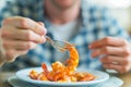 Enjoying seafood: Man savors boiled shrimp at home