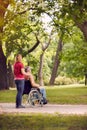 Enjoying senior man in wheelchair and daughter in the park Royalty Free Stock Photo